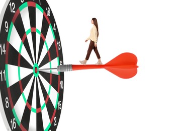 Image of Concepts of targeting, decision and goal achievement. Woman walking on dart sticking in center of dartboard against white background