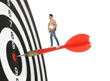Image of Targeting, goal achievement. Art collage with man standing on dart sticking in center of dartboard against white background