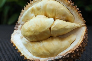 Photo of Fresh ripe durian on table outdoors, closeup