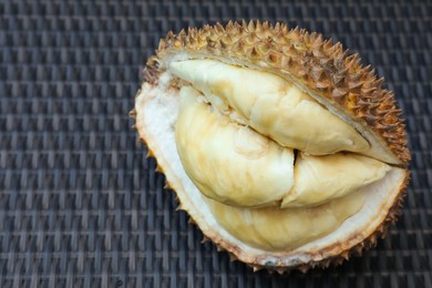 Photo of Fresh ripe durian on wicker table, above view. Space for text