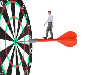 Image of Targeting, goal achievement. Art collage with businessman walking on dart sticking in center of dartboard against white background