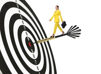 Image of Goal achievement, business success and targeting. Businesswoman walking on dart sticking in center of dartboard against white background