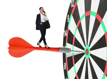 Image of Goal achievement, business success and targeting. Businesswoman walking on dart sticking in center of dartboard against white background