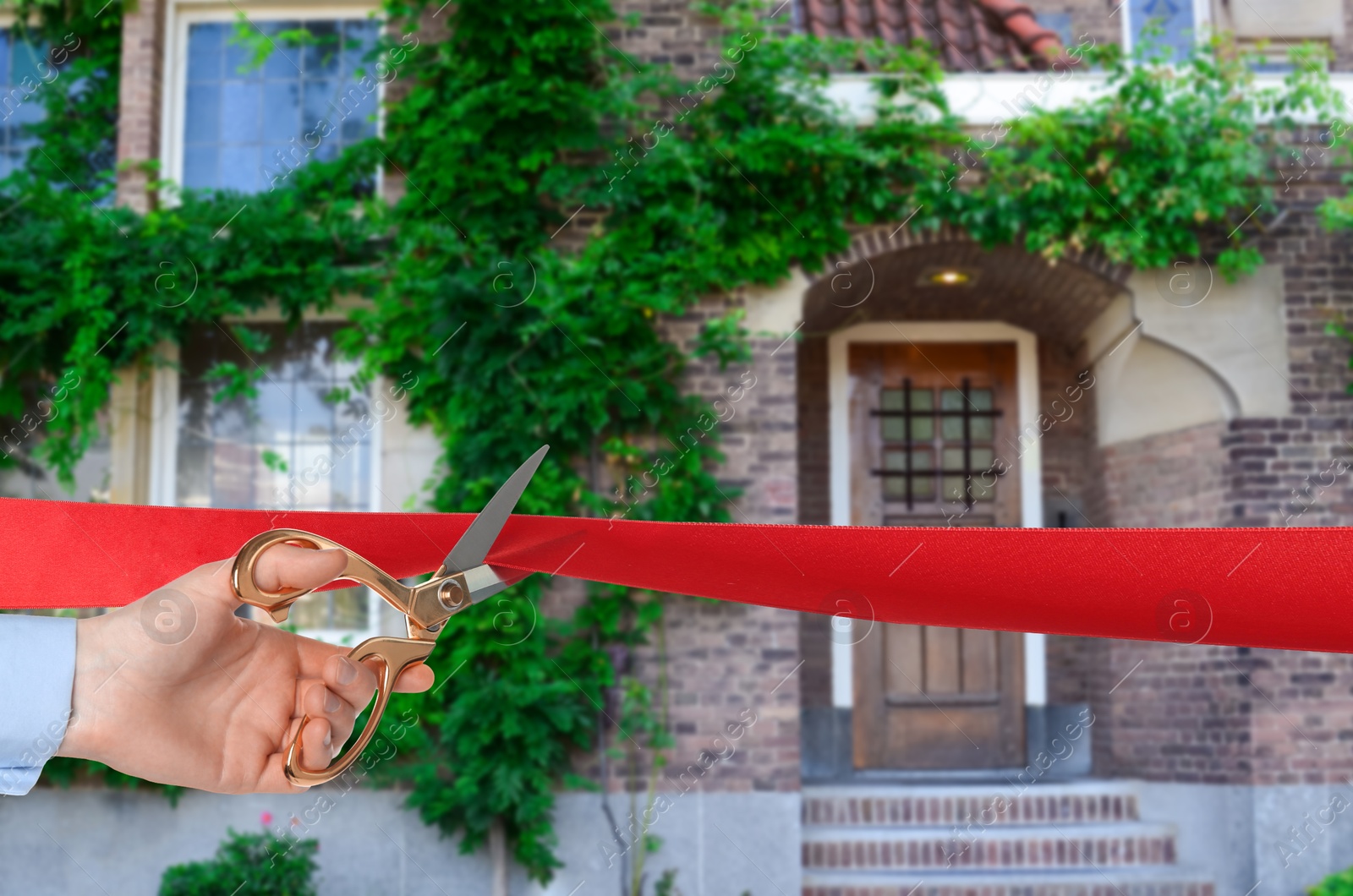 Man cutting red ribbon at opening ceremony of housing estate, closeup Image of Man cutting red ribbon at opening ceremony of housing estate, closeup