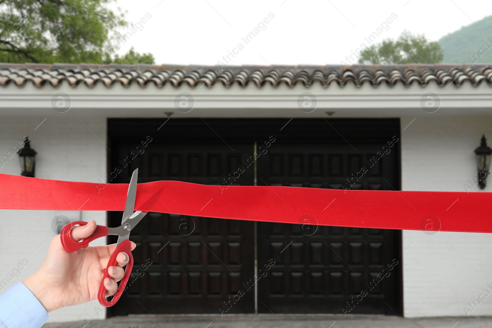 Man cutting red ribbon at opening ceremony of house, closeup Image of Man cutting red ribbon at opening ceremony of house, closeup