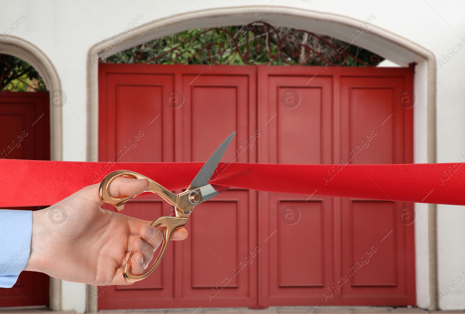 Man cutting red ribbon at opening ceremony of house, closeup Image of Man cutting red ribbon at opening ceremony of house, closeup