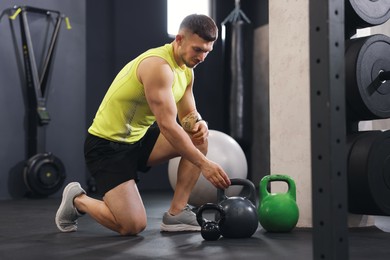 Photo of Personal trainer with sports equipment in gym