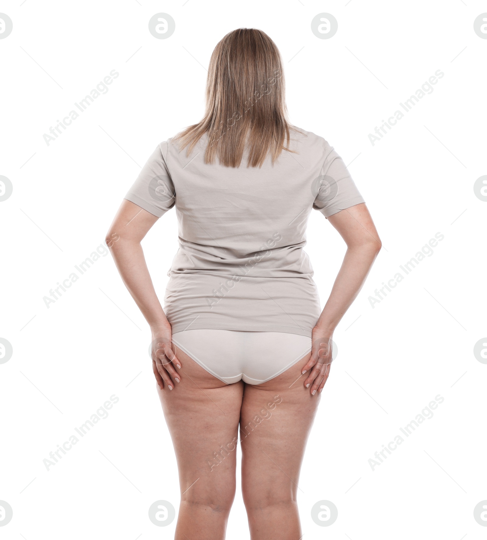 Weight loss. Plus size woman on white background, back view Photo of Weight loss. Plus size woman on white background, back view