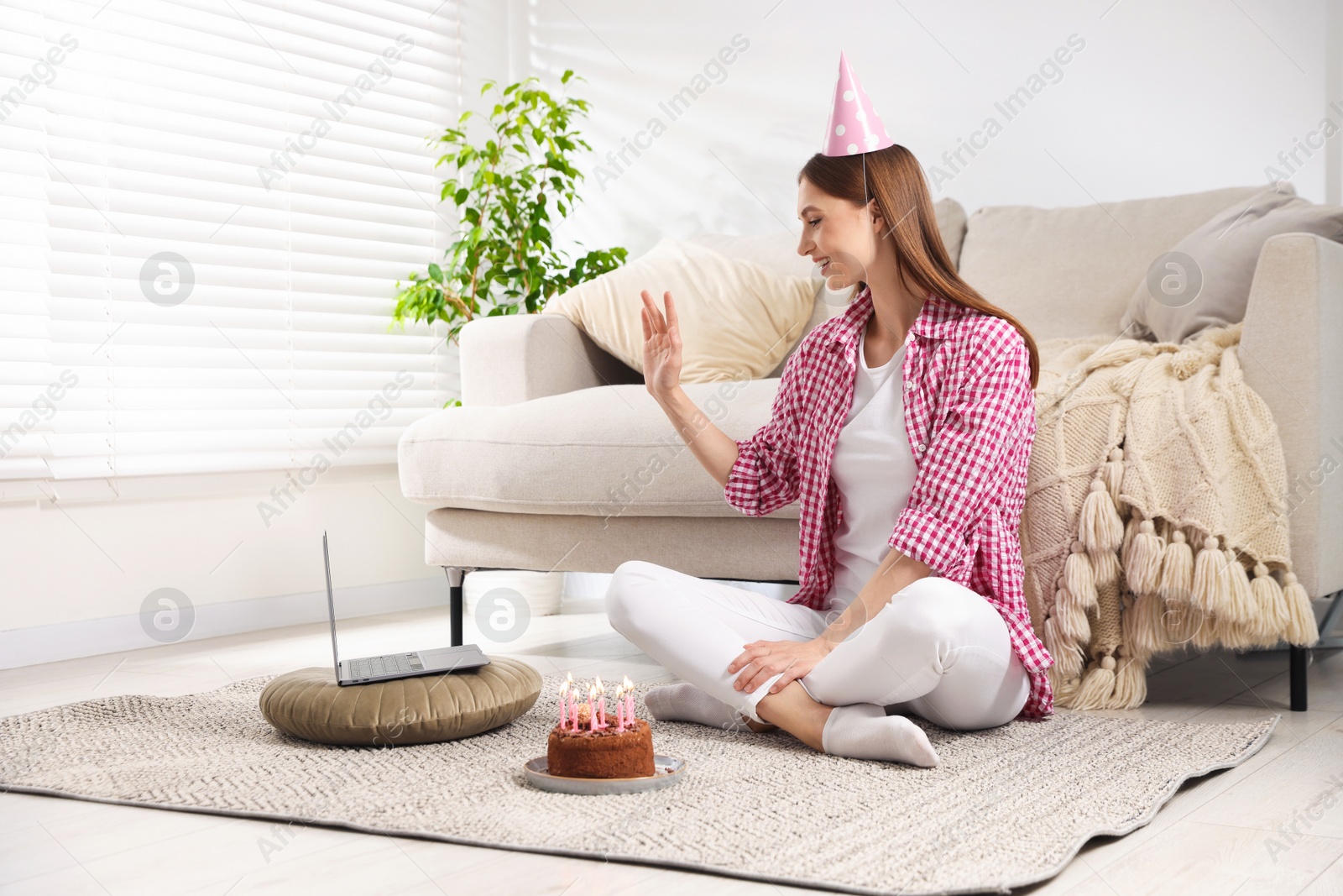 Birthday celebration. Happy woman with tasty cake having video call via laptop at home Photo of Birthday celebration. Happy woman with tasty cake having video call via laptop at home