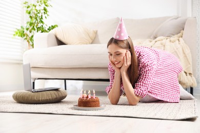 Photo of Birthday celebration. Happy woman with tasty cake having video call via laptop at home