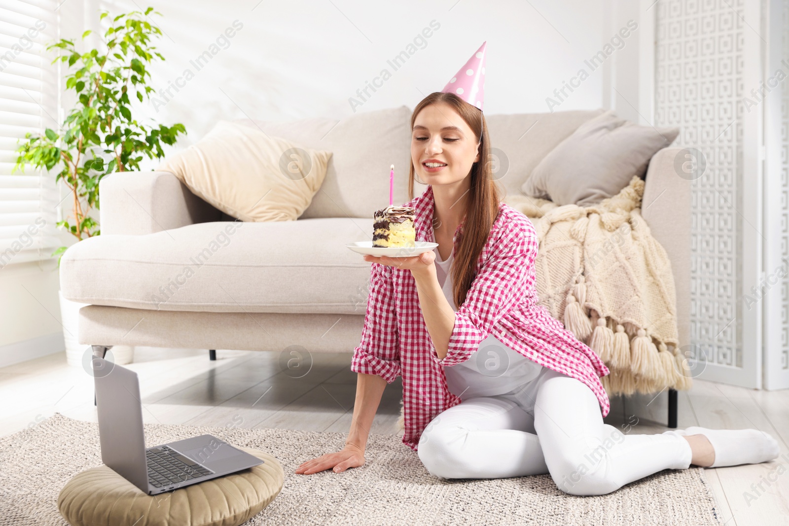 Birthday celebration. Happy woman with piece of cake having video call via laptop at home Photo of Birthday celebration. Happy woman with piece of cake having video call via laptop at home