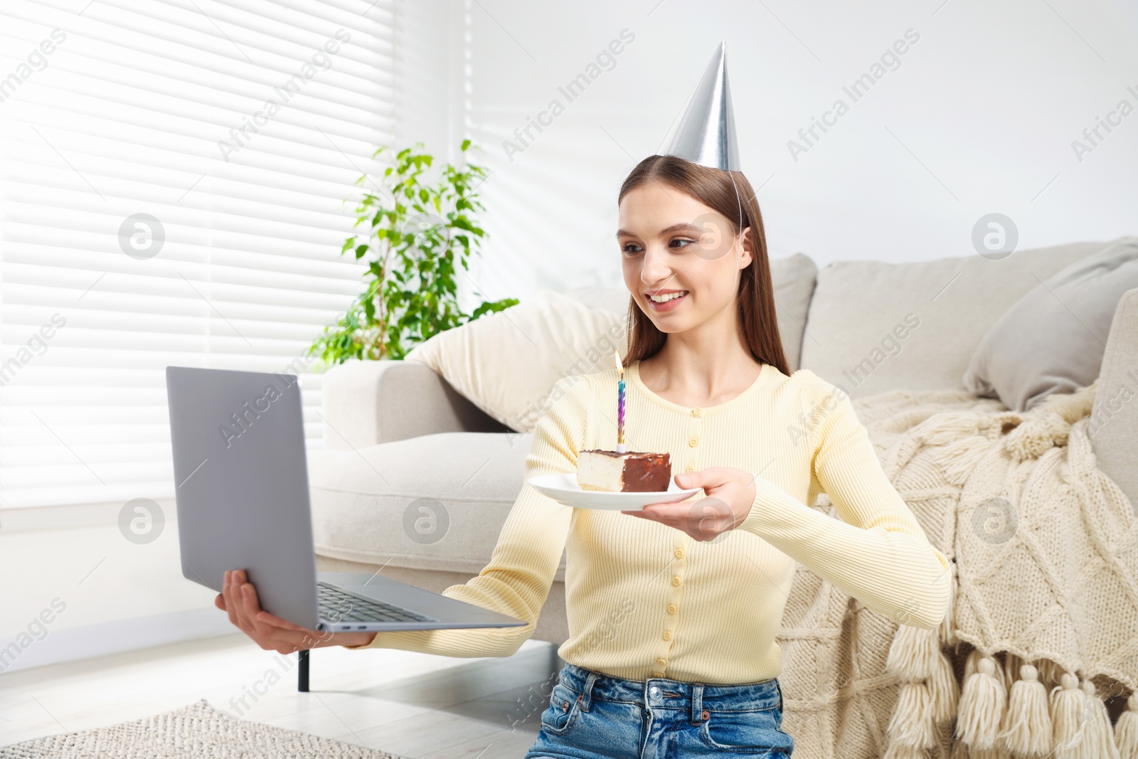 Birthday celebration. Happy woman with piece of cake having video call via laptop at home Photo of Birthday celebration. Happy woman with piece of cake having video call via laptop at home