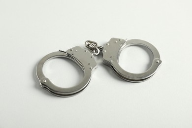 Photo of Handcuffs on white background, above view. Police equipment