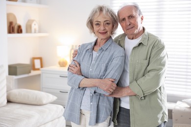 Photo of Portrait of lovely senior couple at home, space for text