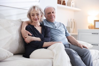 Photo of Lovely senior couple relaxing together on sofa at home