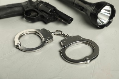 Photo of Different police equipment on light grey table, closeup