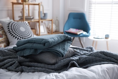 Photo of Fresh linens on bed indoors. Home textile