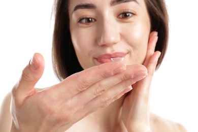 Photo of Woman with contact lens on white background, selective focus