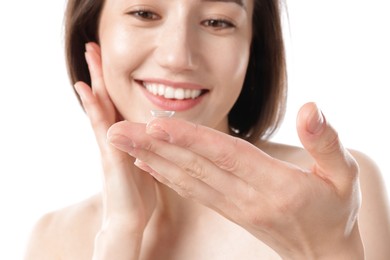 Photo of Woman with contact lens on white background, selective focus