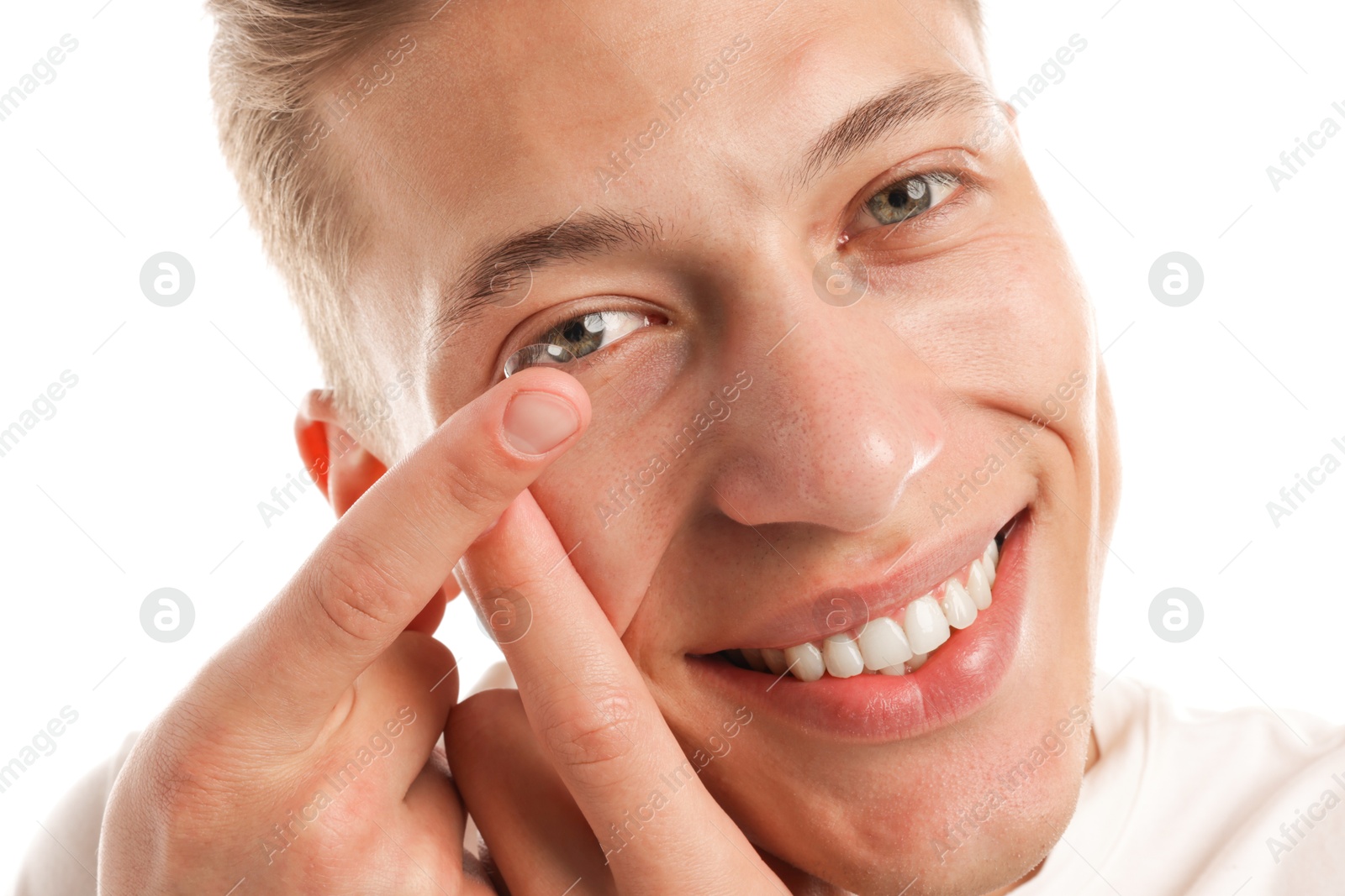 Man putting in contact lens on white background, closeup Photo of Man putting in contact lens on white background, closeup
