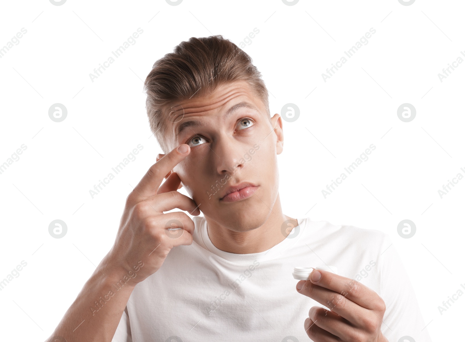 Man putting in contact lenses on white background Photo of Man putting in contact lenses on white background
