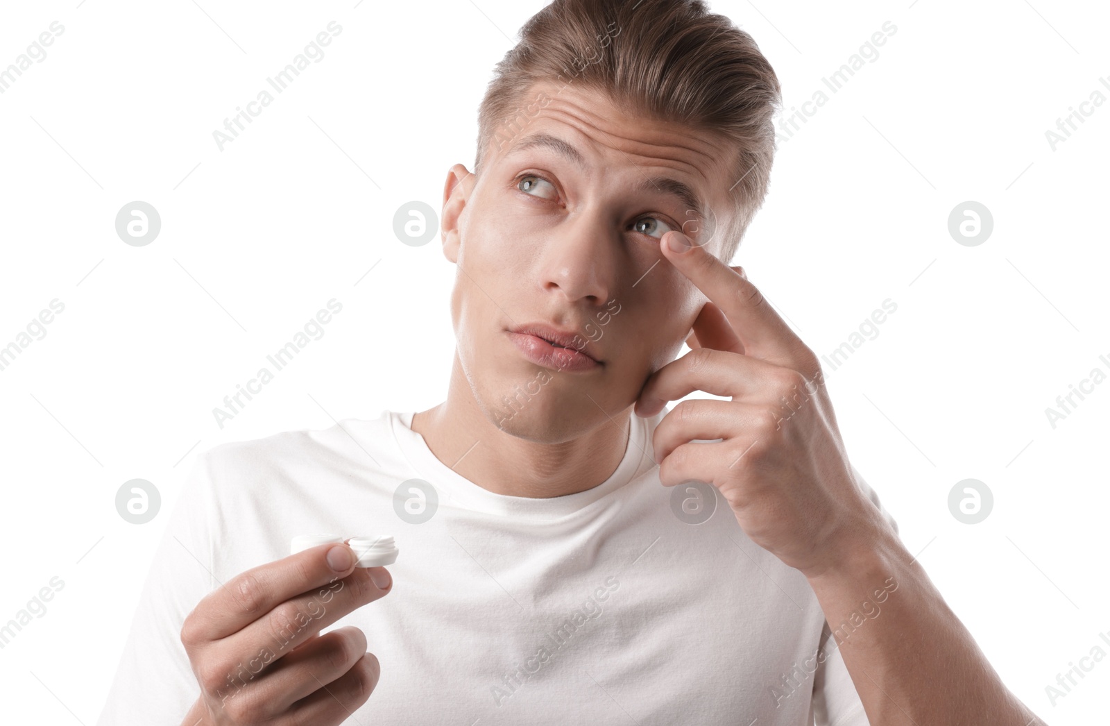 Man putting in contact lenses on white background Photo of Man putting in contact lenses on white background