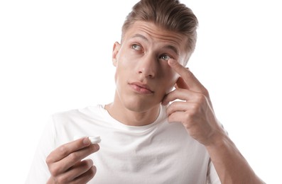Photo of Man putting in contact lenses on white background