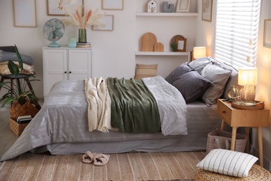 Photo of Comfortable bed with soft linens and blankets in room. Home textile
