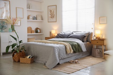 Photo of Comfortable bed with soft linens and blankets in room. Home textile