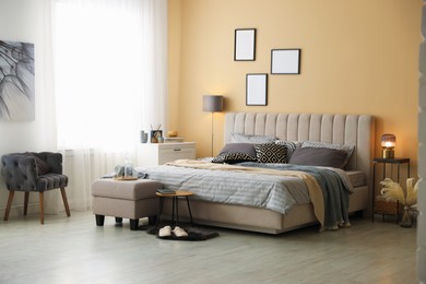 Photo of Comfortable bed with soft linens and blankets in room. Home textile