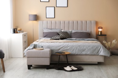 Photo of Comfortable bed with soft linens and blankets in room. Home textile