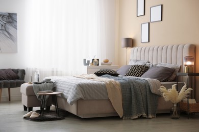 Photo of Comfortable bed with soft linens and blankets in room. Home textile