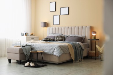 Photo of Comfortable bed with soft linens and blankets in room. Home textile