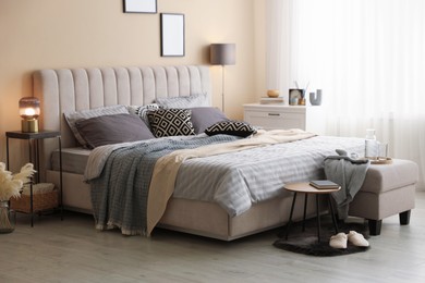 Photo of Comfortable bed with soft linens and blankets in room. Home textile