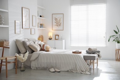Photo of Comfortable bed with soft linens in room. Home textile