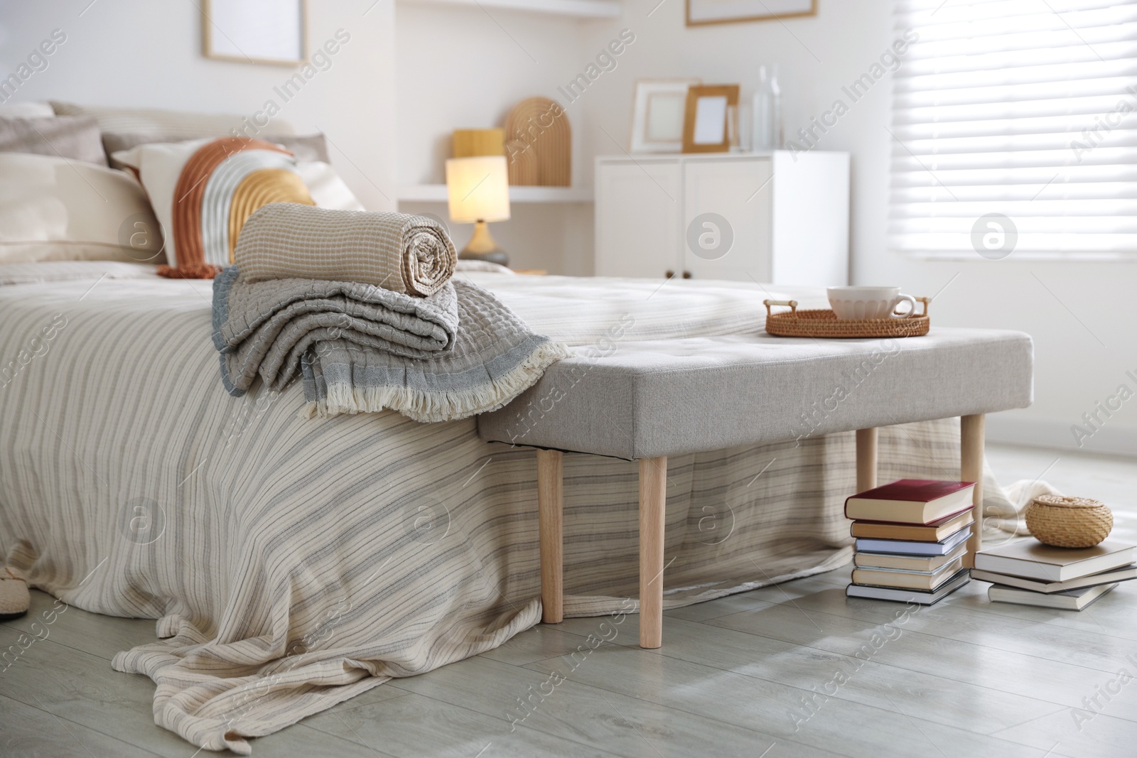 Comfortable bed with soft linens in room. Home textile Photo of Comfortable bed with soft linens in room. Home textile