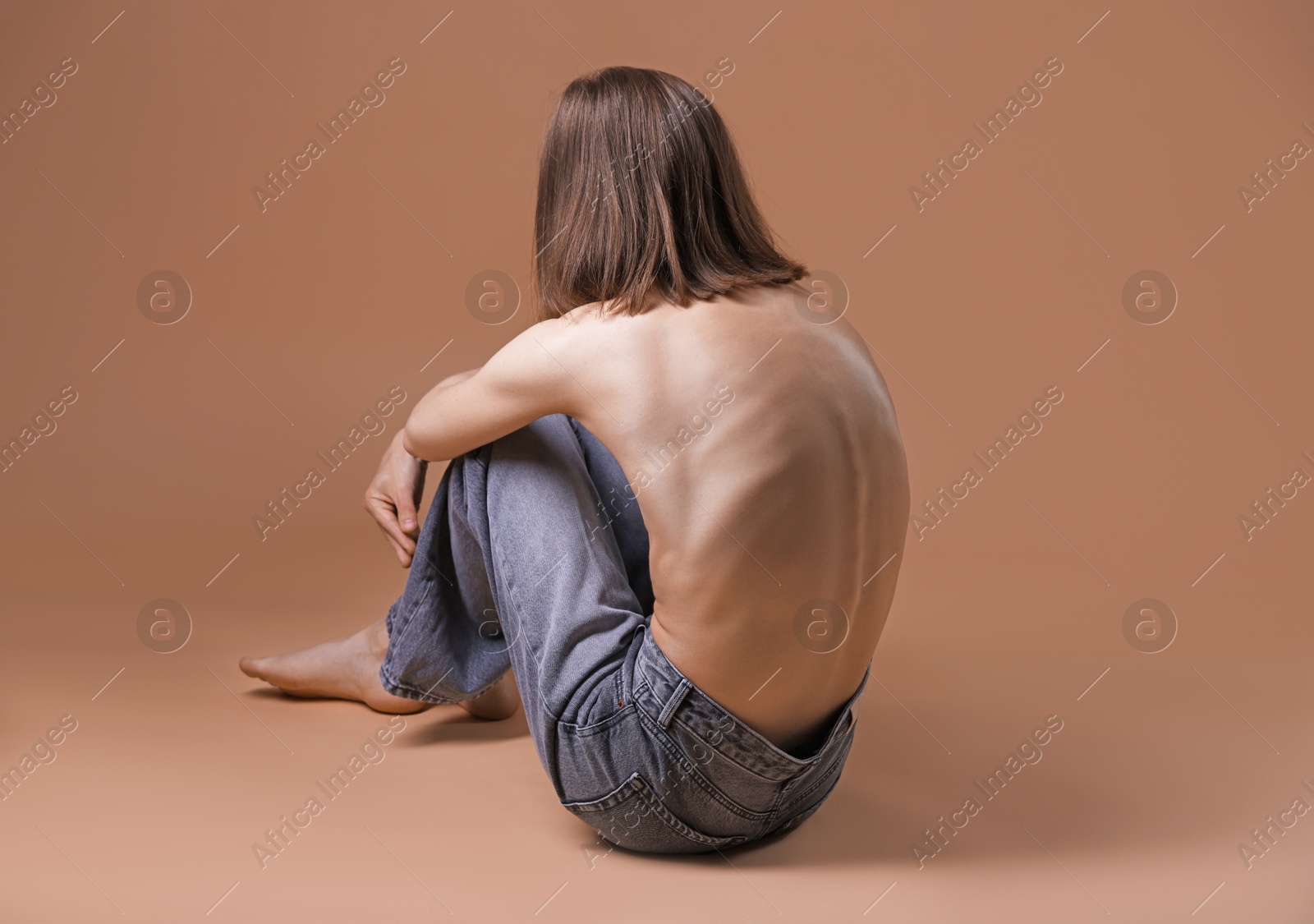 Woman suffering from anorexia on dark beige background Photo of Woman suffering from anorexia on dark beige background