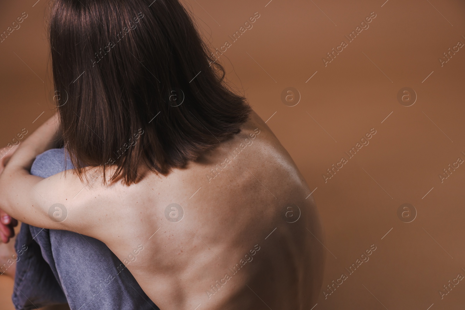 Woman suffering from anorexia on dark beige background, closeup. Space for text Photo of Woman suffering from anorexia on dark beige background, closeup. Space for text