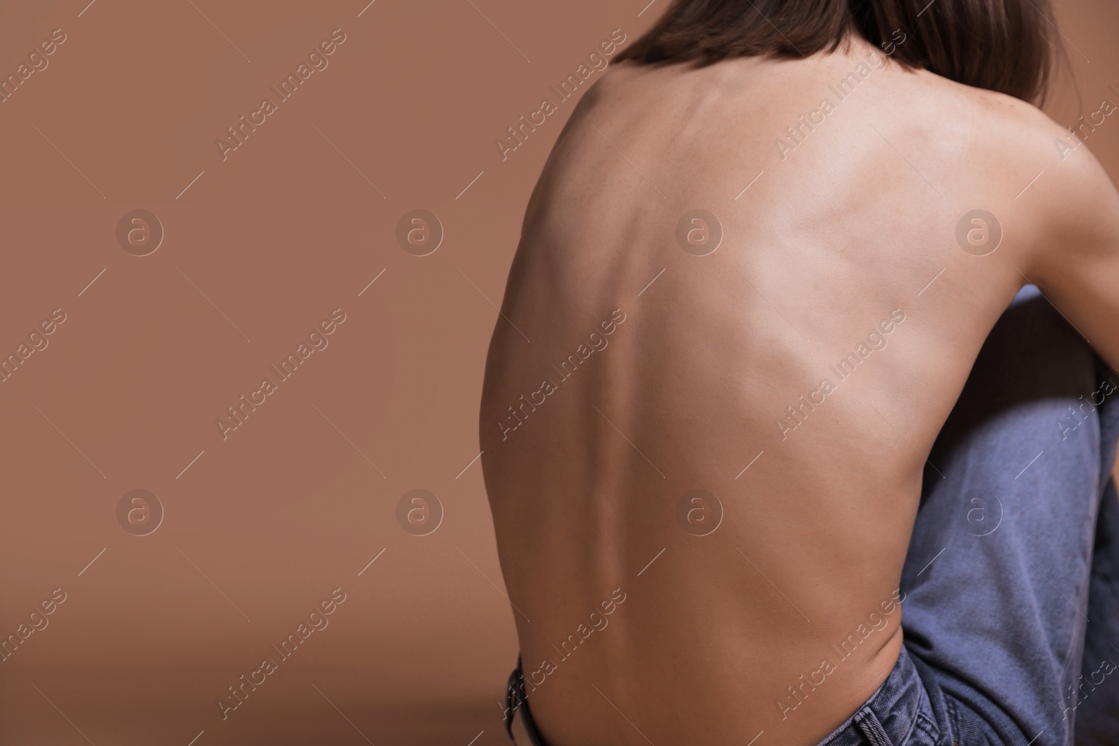 Woman suffering from anorexia on dark beige background, closeup. Space for text Photo of Woman suffering from anorexia on dark beige background, closeup. Space for text