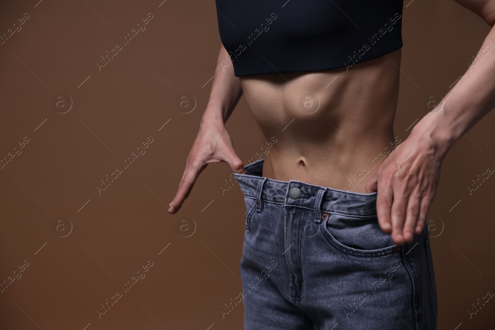 Woman suffering from anorexia on brown background, closeup. Space for text Photo of Woman suffering from anorexia on brown background, closeup. Space for text