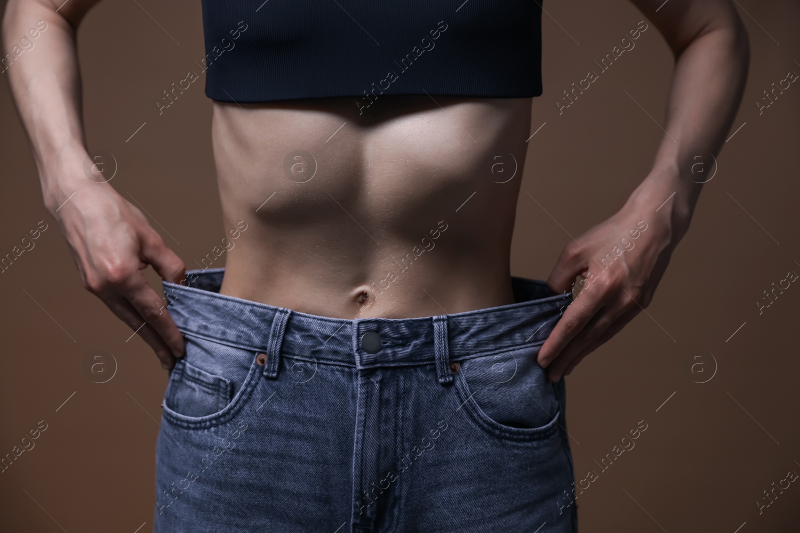 Woman suffering from anorexia on brown background, closeup Photo of Woman suffering from anorexia on brown background, closeup