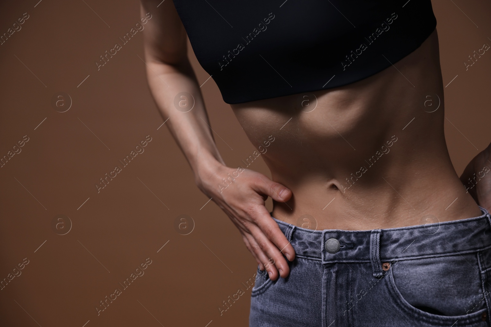 Woman suffering from anorexia on brown background, closeup. Space for text Photo of Woman suffering from anorexia on brown background, closeup. Space for text