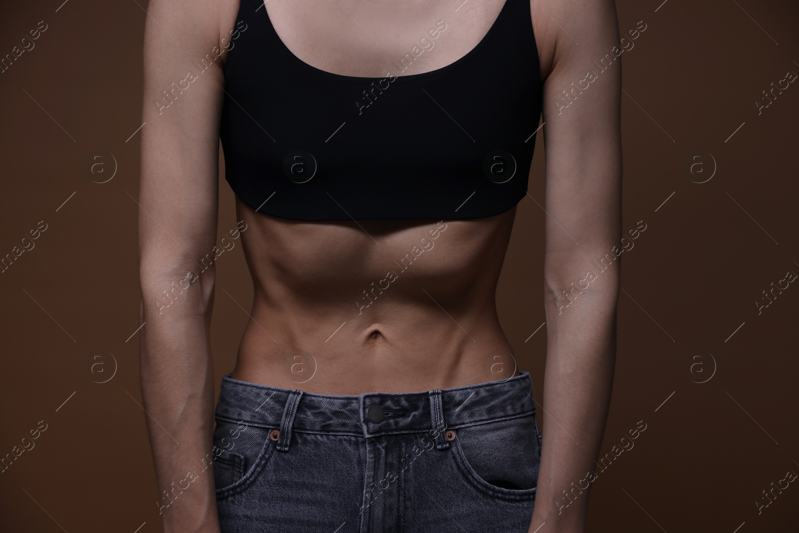 Woman suffering from anorexia on brown background, closeup Photo of Woman suffering from anorexia on brown background, closeup
