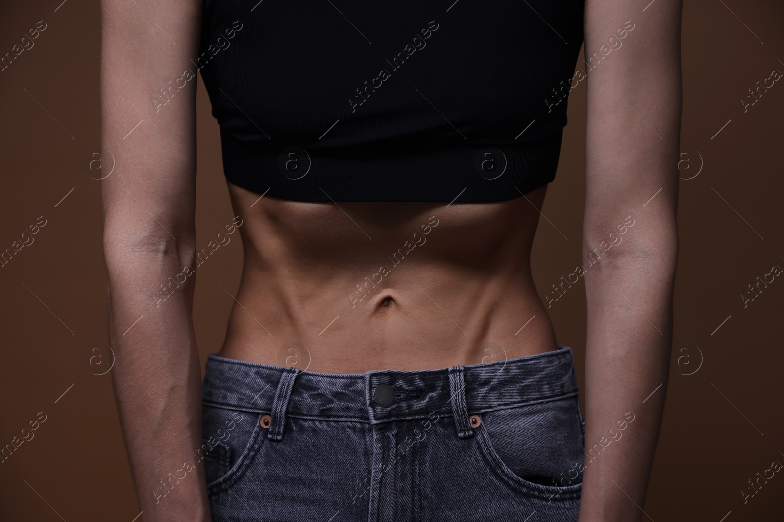 Woman suffering from anorexia on brown background, closeup Photo of Woman suffering from anorexia on brown background, closeup