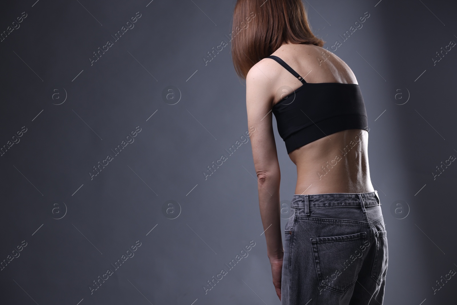 Woman suffering from anorexia on grey background, closeup. Space for text Photo of Woman suffering from anorexia on grey background, closeup. Space for text