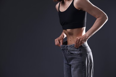Photo of Woman suffering from anorexia on grey background, closeup. Space for text