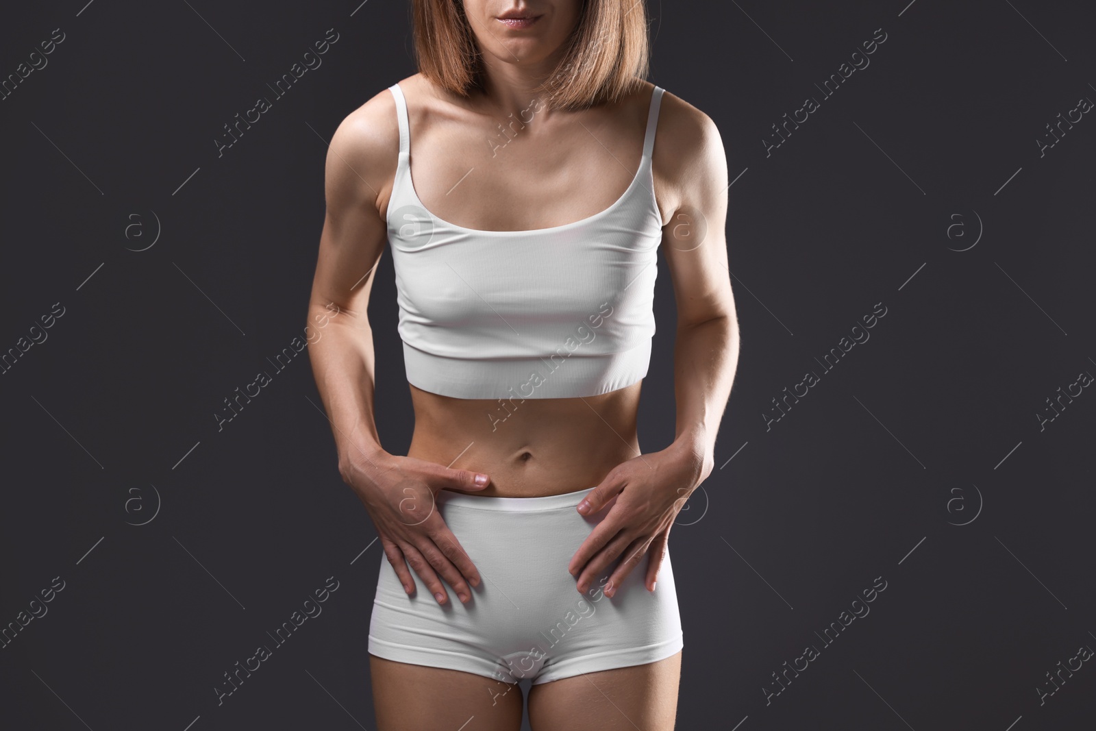 Woman suffering from anorexia on grey background, closeup Photo of Woman suffering from anorexia on grey background, closeup