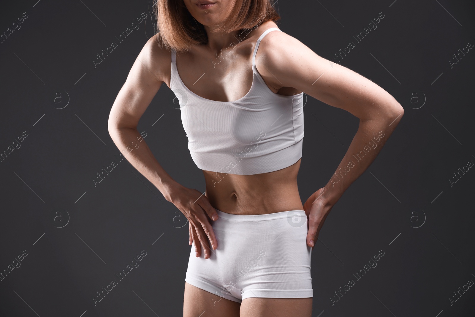 Woman suffering from anorexia on grey background, closeup Photo of Woman suffering from anorexia on grey background, closeup
