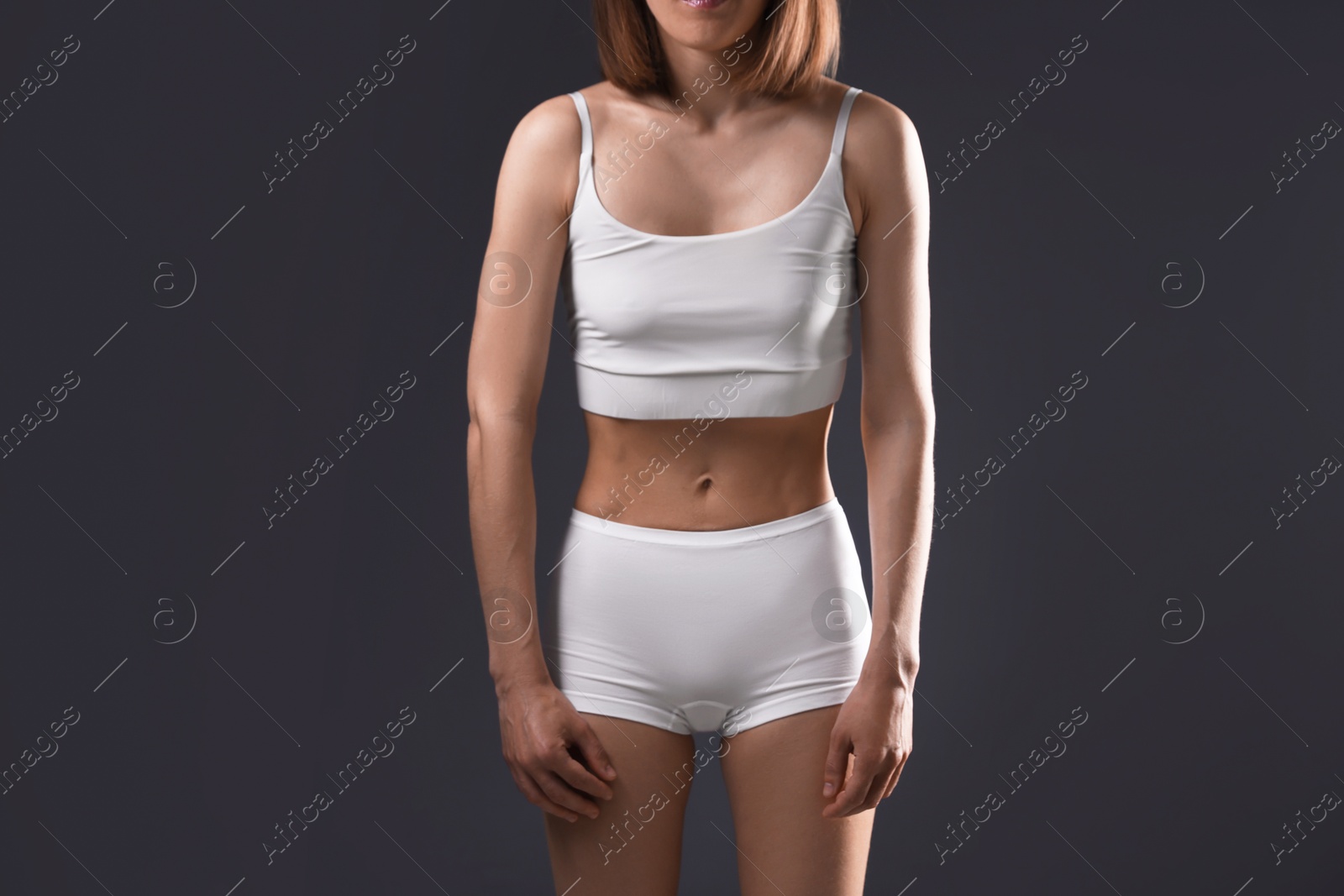 Woman suffering from anorexia on grey background, closeup Photo of Woman suffering from anorexia on grey background, closeup