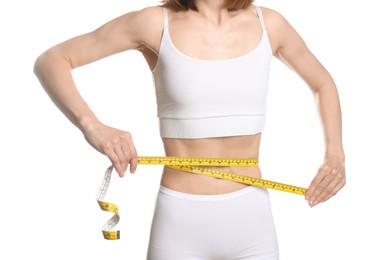 Photo of Anorexic woman measuring her waist on white background, closeup